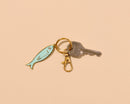 And Here We Are - Sardine Enamel Keychain & Bag Charm - Foodie, Seafood, Anchovy, Tinned Fish, Ocean, Fisherman - Stocking stuffer, Holiday, Gift Guide