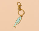 And Here We Are - Sardine Enamel Keychain & Bag Charm - Foodie, Seafood, Anchovy, Tinned Fish, Ocean, Fisherman - Stocking stuffer, Holiday, Gift Guide
