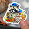 HOLOGRAPHIC STICKER: "Foodie" Raccoon with Garbage Feast